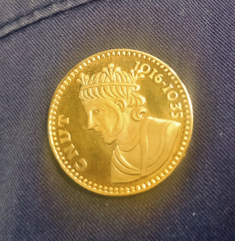 A gold coin with the face of an old woman.