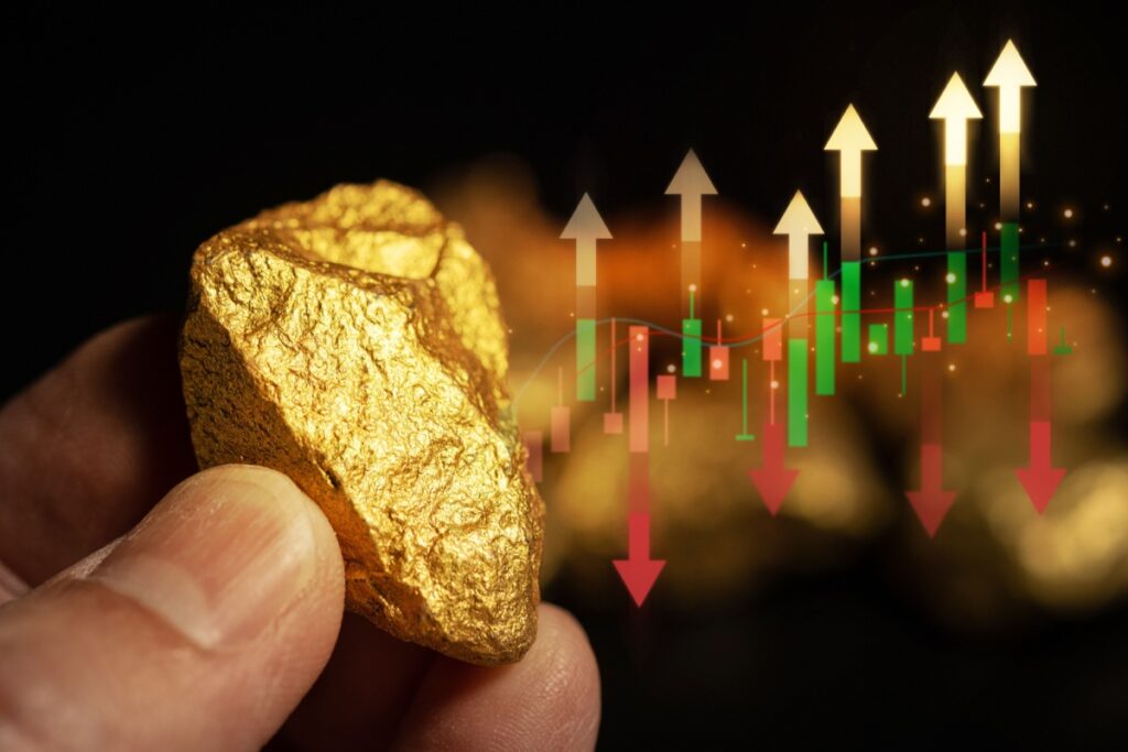 A hand holding a gold nugget with arrows in the background.
